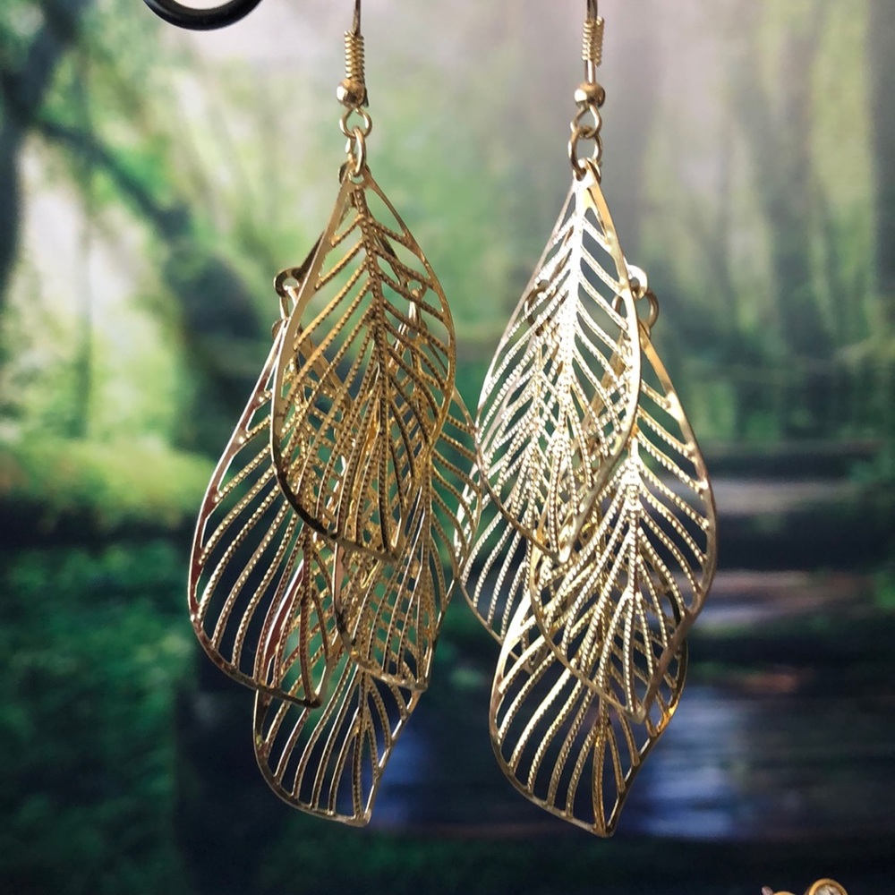 Long feather style gold earrings